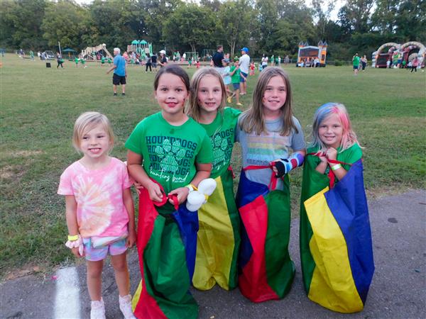 Students outside enjoying a family fun night for their school.